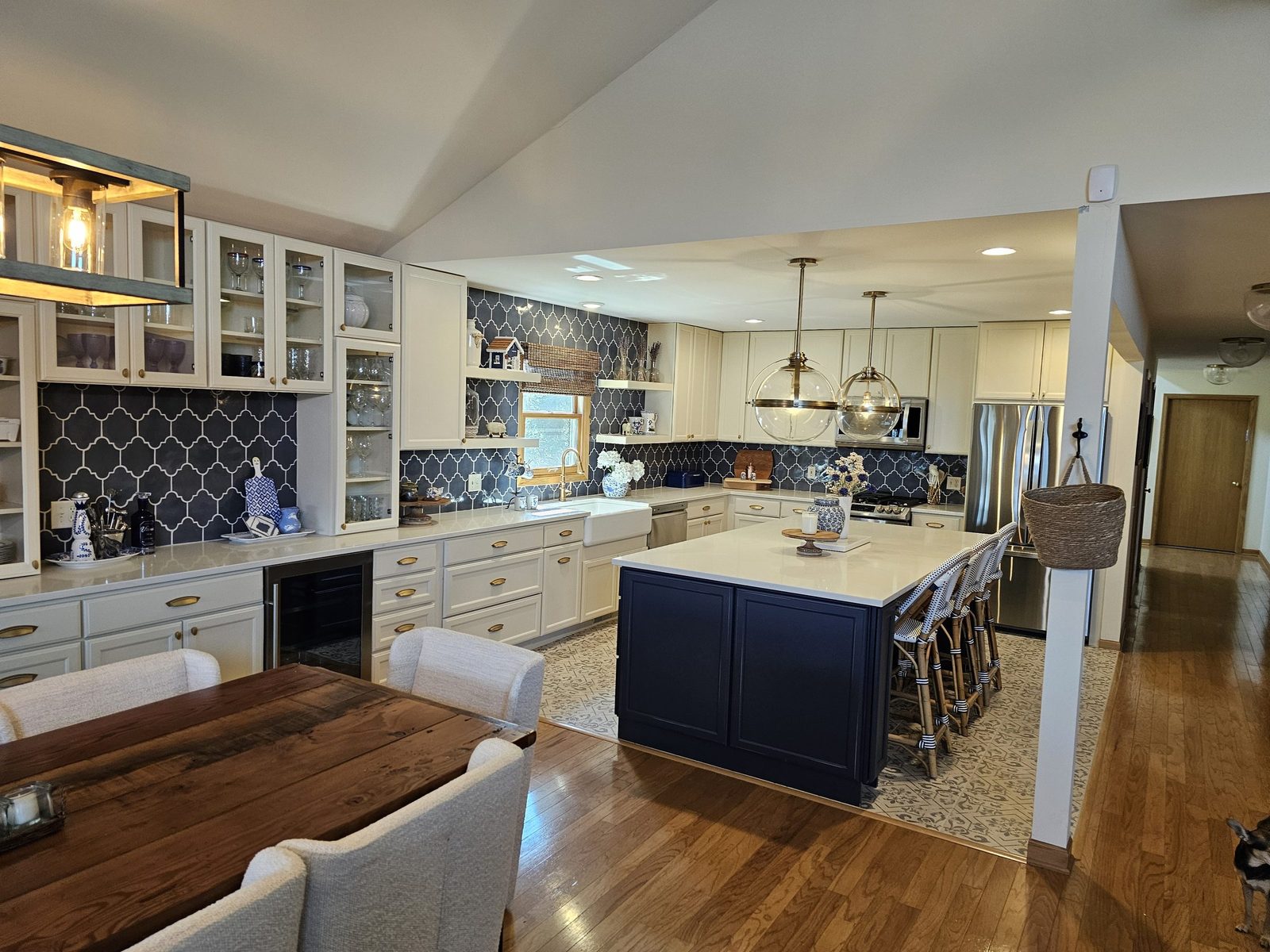 Lake house kitchen with navy island and arabesque tile backsplash