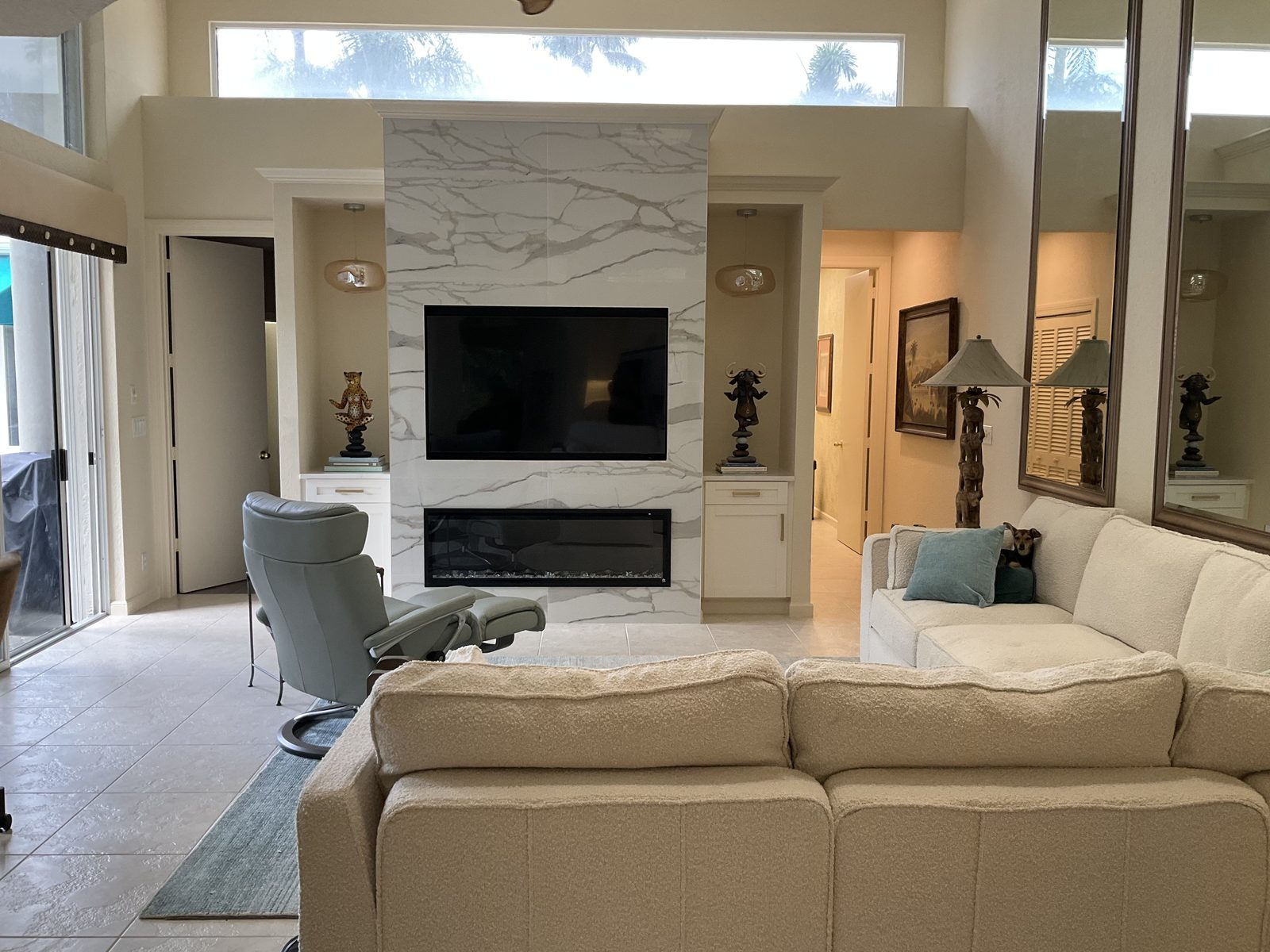 Living room with full height marble fireplace surround