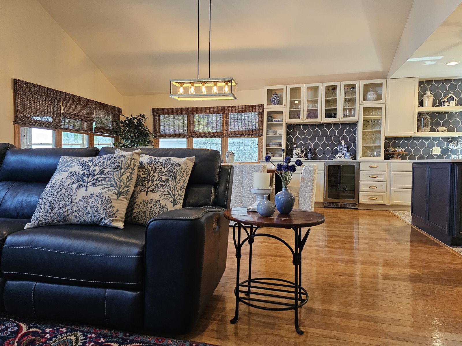 Living room seating looking through to the kitchen and bar cabinetry